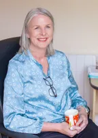 Nichola Lynagh seated with a cup of coffee